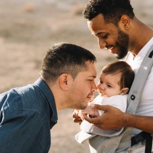 Two people with a baby