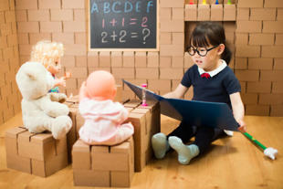 Child role-playing as a teacher