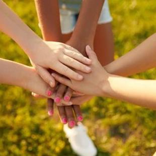 Children's hands overlapping