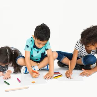 A group of children drawing on a piece of paper
