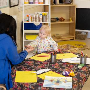 A person and a child drawing.