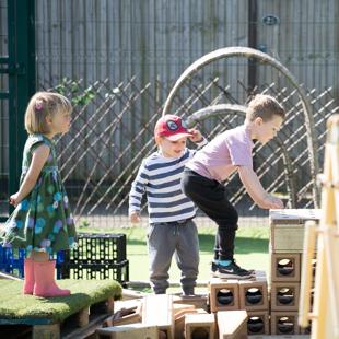 A group of children playing on steps outdoors.