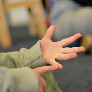 child pointing at fingers and counting