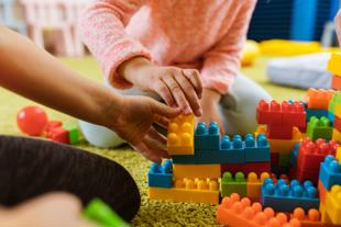 Children playing with colourful plastic building blocks
