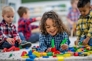 Young children playing with colourful blocks