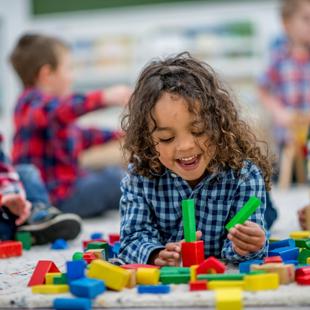 Young children playing with colourful blocks