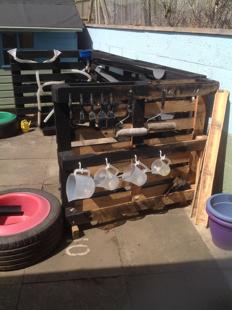 A pallet with a wheel and buckets on it