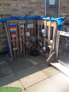 A wooden pallet with pots and pans