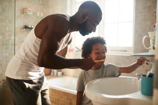 Parent brushing child's teeth