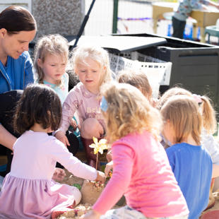 A group of children playing in sand