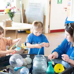 A group of children playing with objects in water