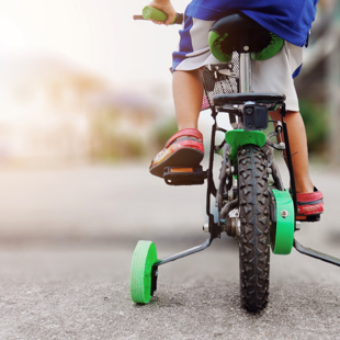 child on a bicycle with the training wheels