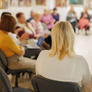 a group session with participants seated in a circle, engaging in discussion