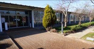 A building with a brick walkway.