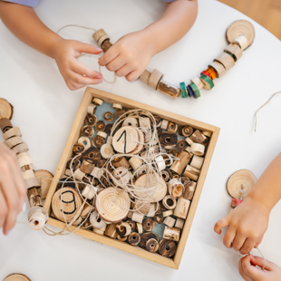 children playing with wooden Montessori toys developing fine motor skills and creativity