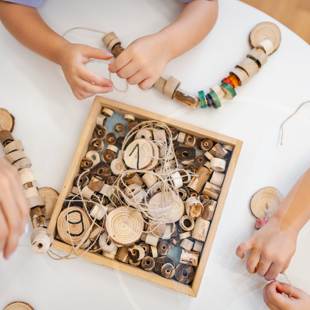 children playing with wooden Montessori toys developing fine motor skills and creativity