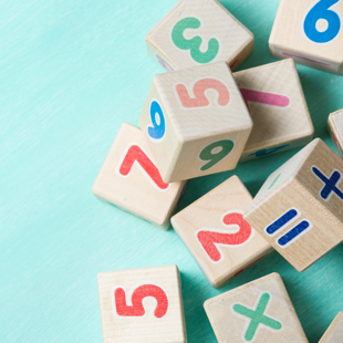 wooden number cubes on a turquoise background
