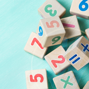 wooden number cubes on a turquoise background