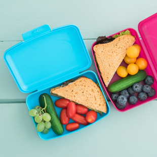 two open lunchboxes containing healthy snacks