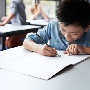 Child writing on notebook