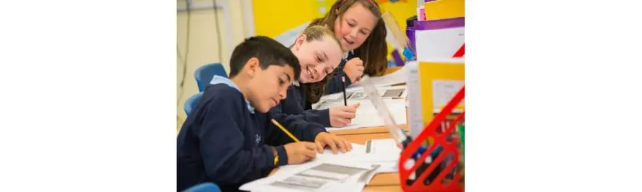 Children writing in a book