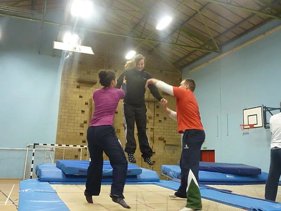 Three adults on a trampoline